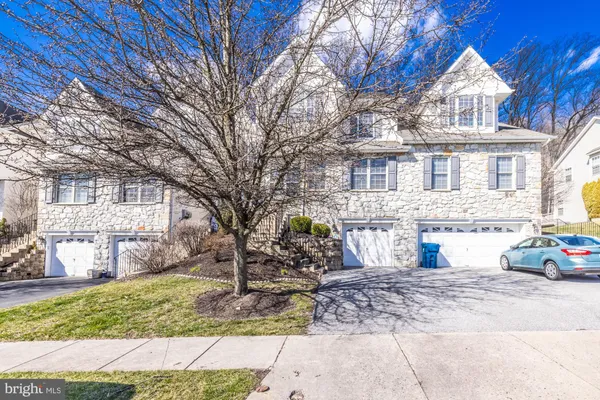 a view of a white house with a yard covered with snow
