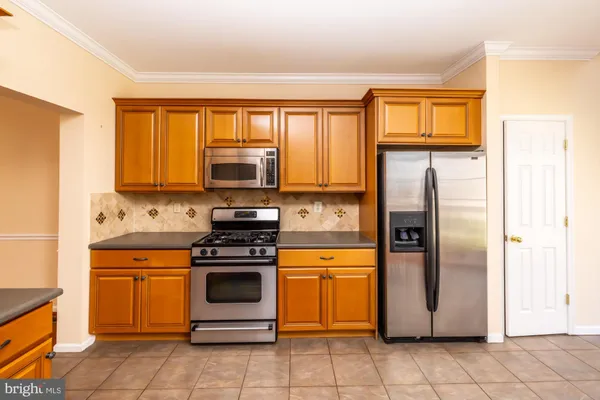 a kitchen with a stove microwave and refrigerator