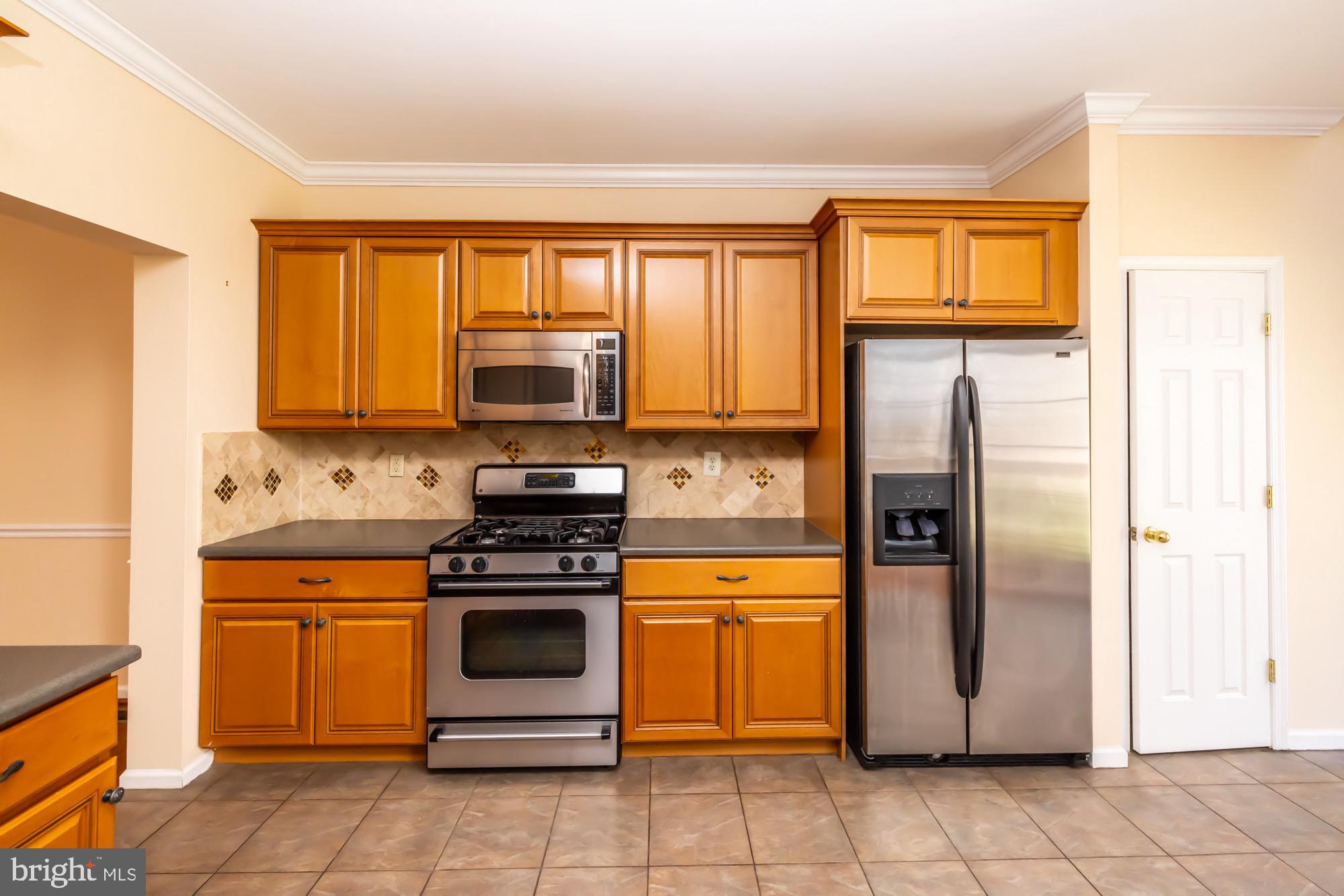 145 Madison Way Downingtown, PA 19335 - Photo 5 of 45 a kitchen with a stove microwave and refrigerator