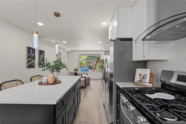 a kitchen with sink stove and cabinets