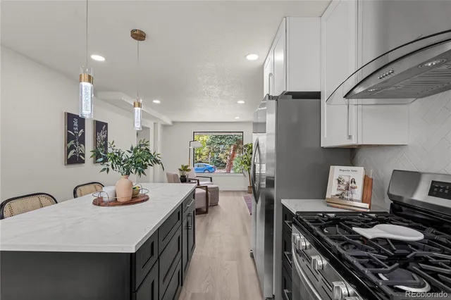 a kitchen with sink stove and cabinets