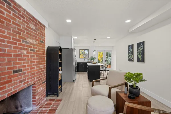 a living room with furniture a potted plant and a fireplace