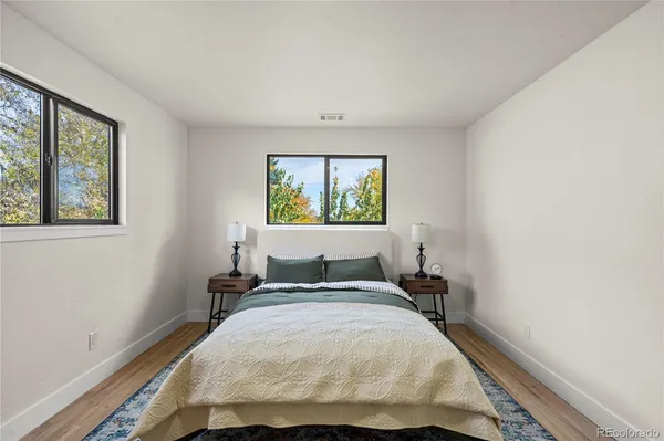 a bedroom with a bed and painting on the wall