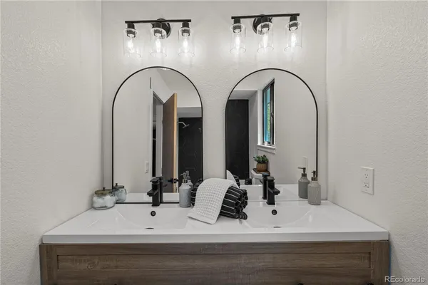 a bathroom with a double vanity sink