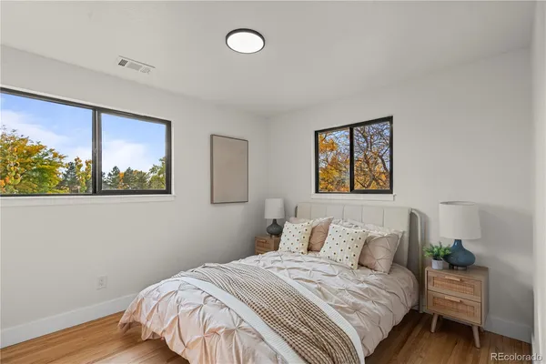 a bedroom with a bed and a painting on the wall