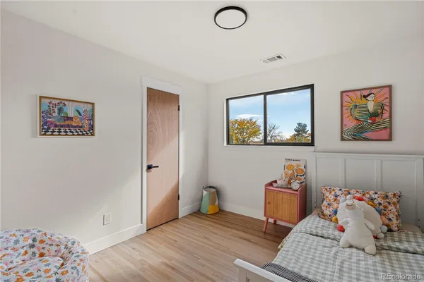 a bedroom with furniture and a window