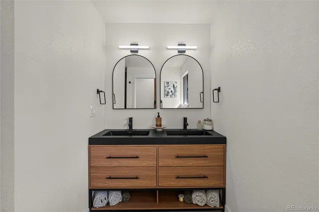 a view of an empty room with wooden floor and windows