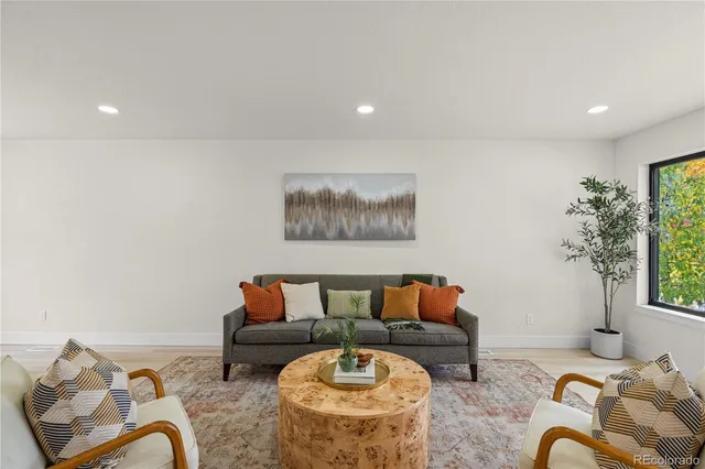 a living room with furniture flowerpot and window