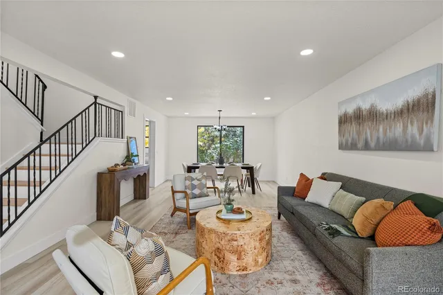 a living room with furniture and wooden floor