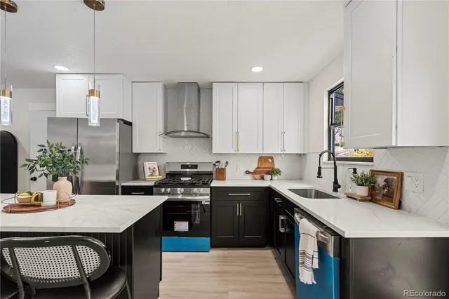 a kitchen with a sink a stove and cabinets