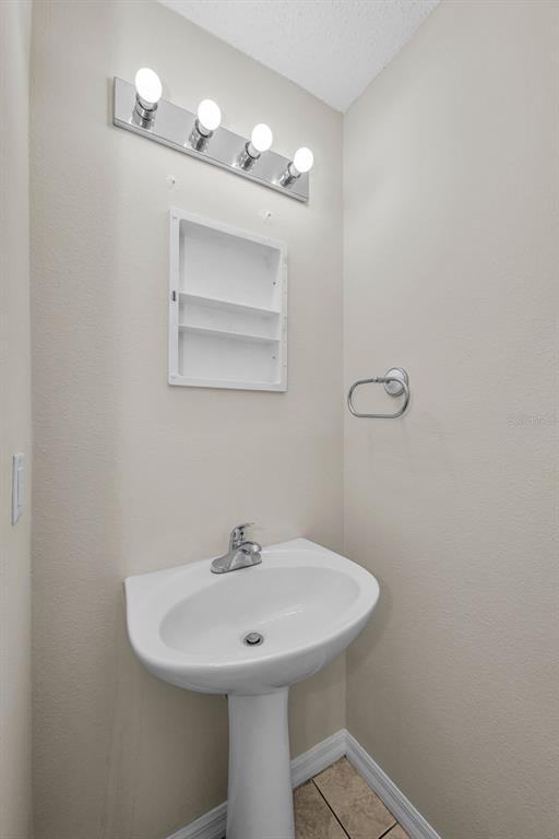 8015 Savannah Sunset Lane Tampa, FL 33615 - Photo 13 of 35 a bathroom with a sink and a mirror
