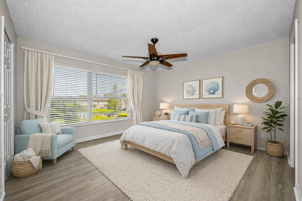 8015 Savannah Sunset Lane Tampa, FL 33615 - Photo 15 of 35 a bed room with a bed and a chandelier