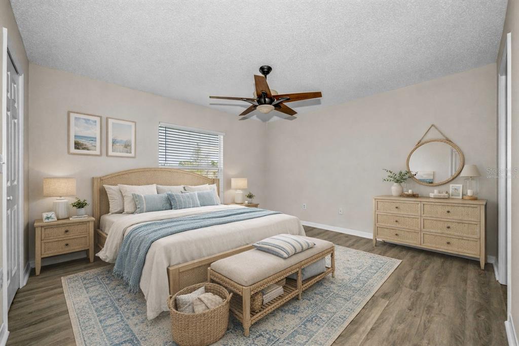 8015 Savannah Sunset Lane Tampa, FL 33615 - Photo 16 of 35 a bed room with a bed and a chandelier