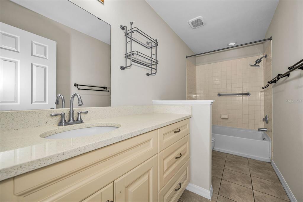 8015 Savannah Sunset Lane Tampa, FL 33615 - Photo 19 of 35 a bathroom with a sink and a mirror