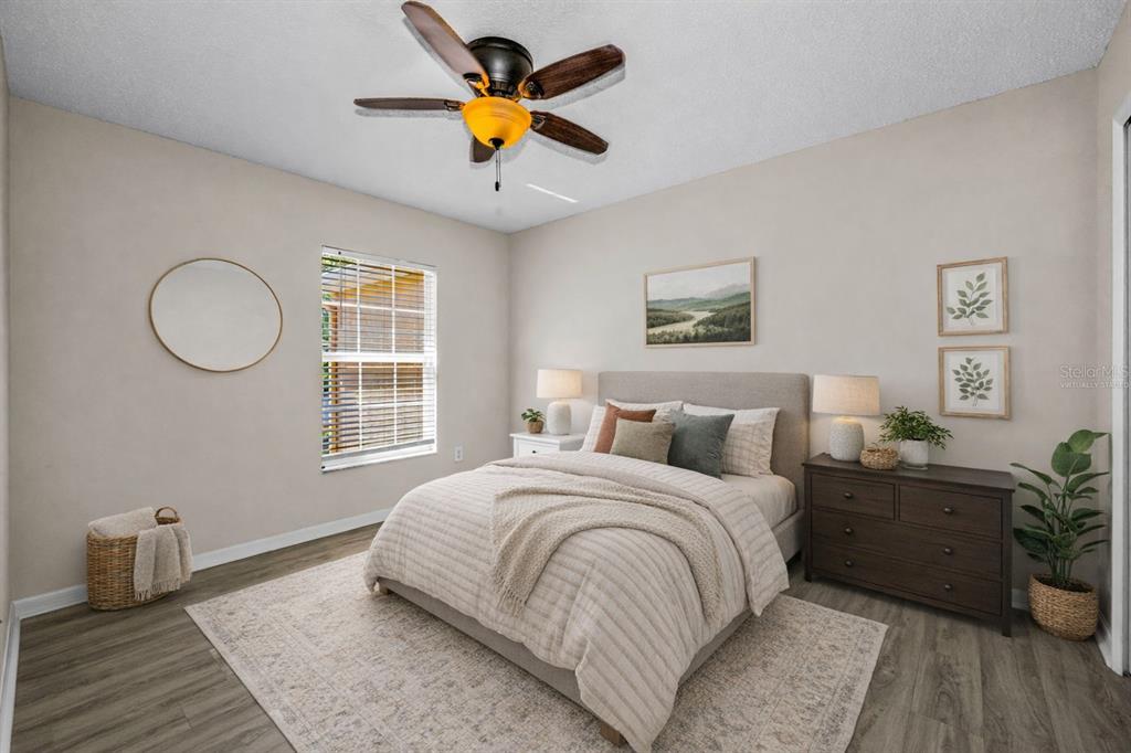 8015 Savannah Sunset Lane Tampa, FL 33615 - Photo 21 of 35 a bedroom with a bed a dresser and window