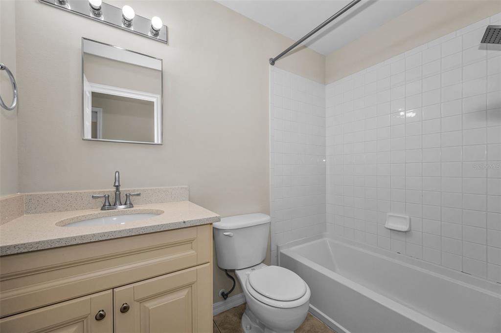 8015 Savannah Sunset Lane Tampa, FL 33615 - Photo 24 of 35 a bathroom with a sink toilet and shower