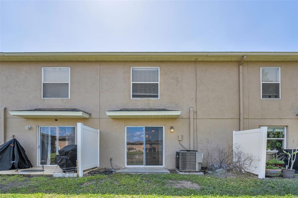 8015 Savannah Sunset Lane Tampa, FL 33615 - Photo 28 of 35 a view of building with yard