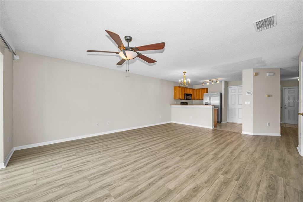 8015 Savannah Sunset Lane Tampa, FL 33615 - Photo 7 of 35 wooden floor in an empty room