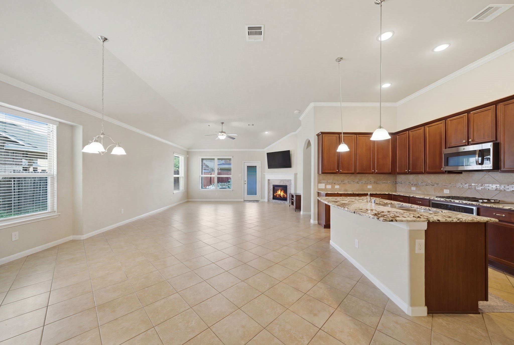 7618 Willow School Drive Spring, TX 77389 - Photo 7 of 19 a view of a kitchen with kitchen island a sink stainless steel appliances and cabinets