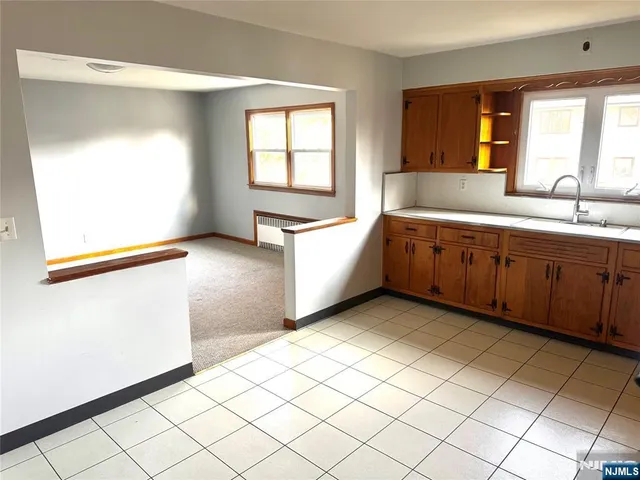 a large white room with a large window vanity and sink