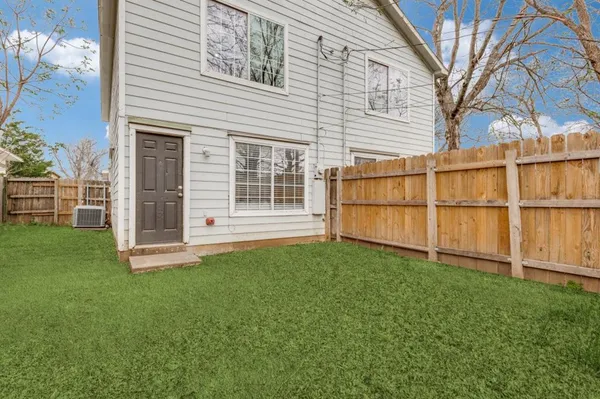a view of a backyard with a large tree