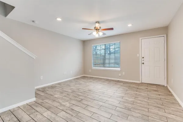 wooden floor in an empty room with a window