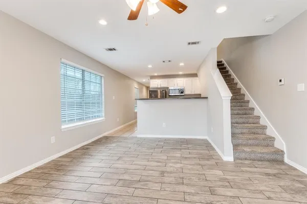 a view of a kitchen with a sink and a window