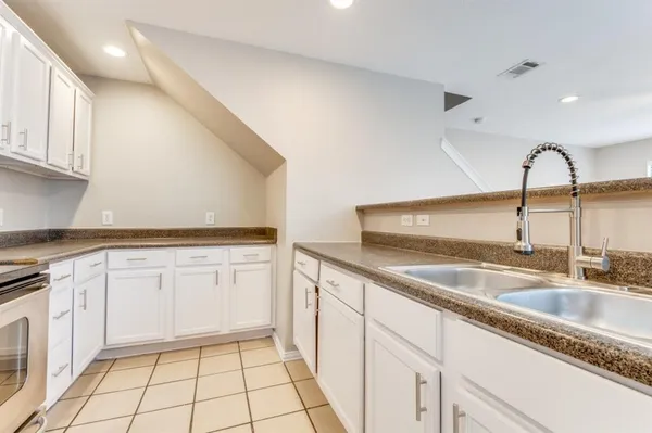 a kitchen with a sink and cabinets