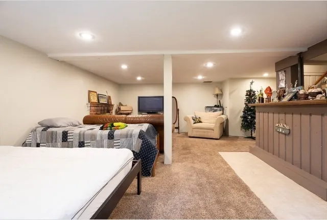 a living room with furniture and a dining table