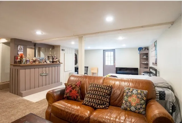 a bedroom with a bed window and couch