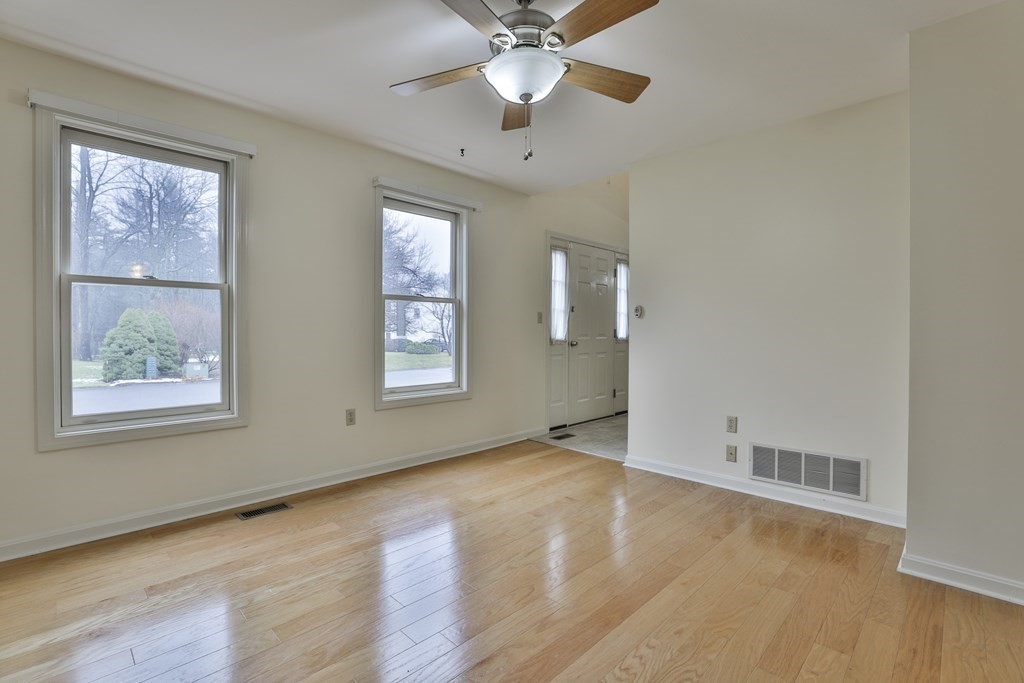 40 Mallard Point Road Merrimack, NH 03054 - Photo 13 of 40 an empty room with wooden floor chandelier fan and windows