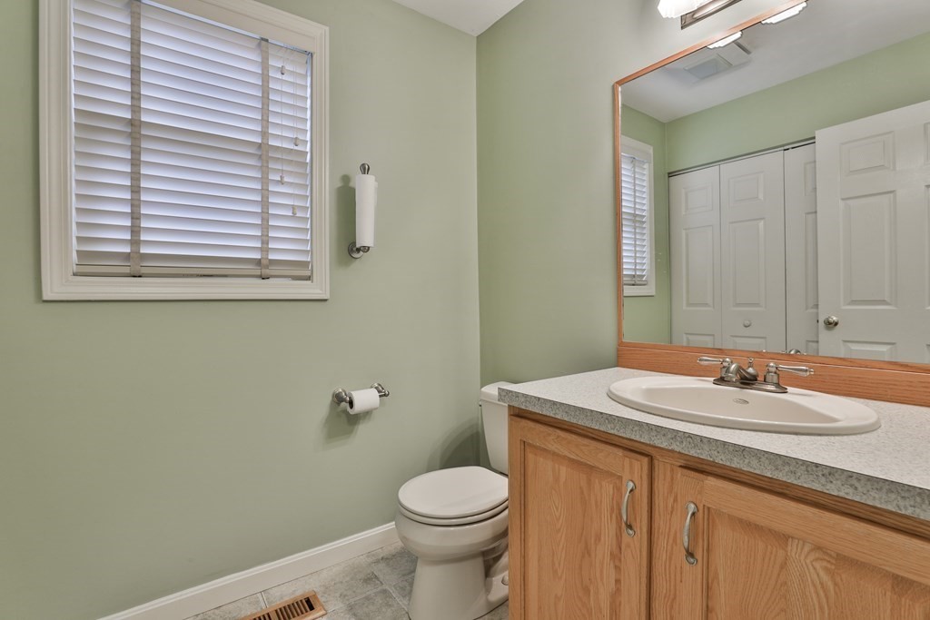 40 Mallard Point Road Merrimack, NH 03054 - Photo 18 of 40 a bathroom with a sink a toilet and a mirror