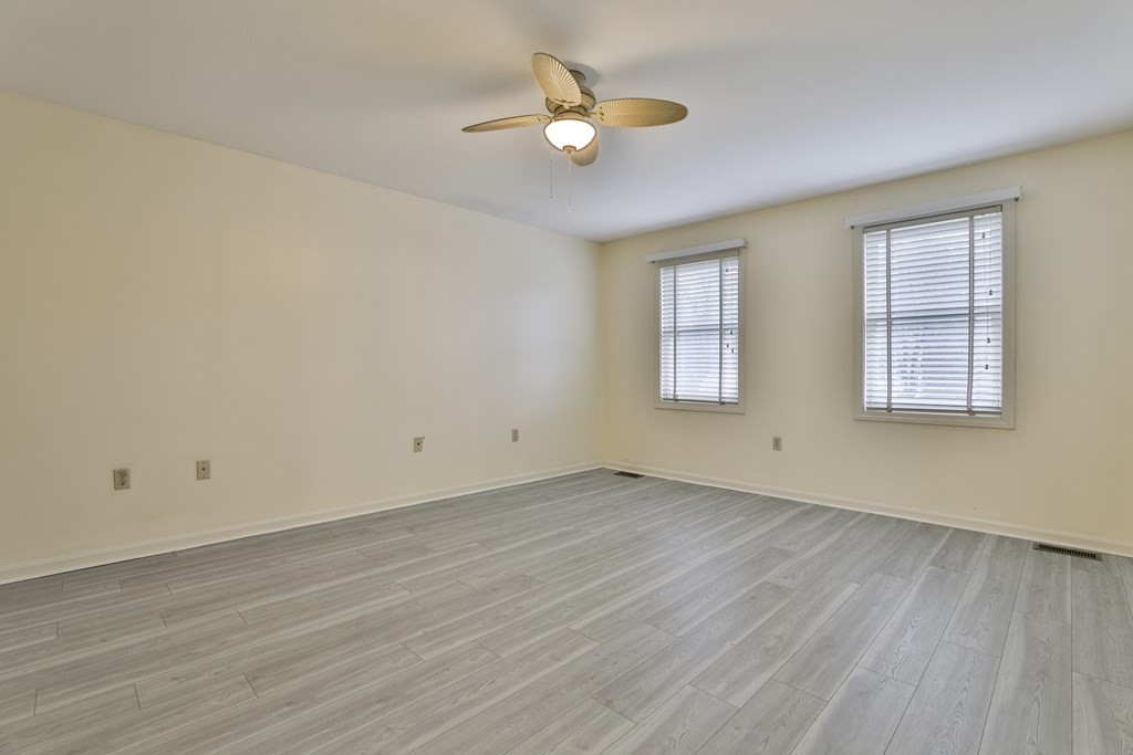 40 Mallard Point Road Merrimack, NH 03054 - Photo 22 of 40 an empty room with wooden floor and windows