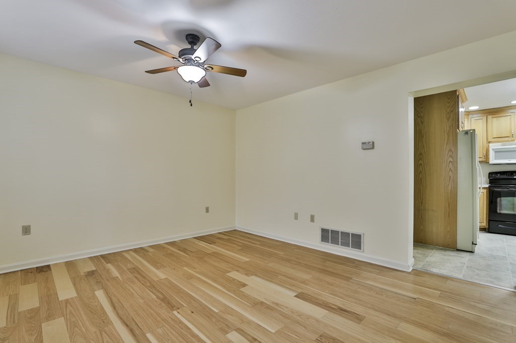40 Mallard Point Road Merrimack, NH 03054 - Photo 3 of 40 wooden floor in an empty room with a window