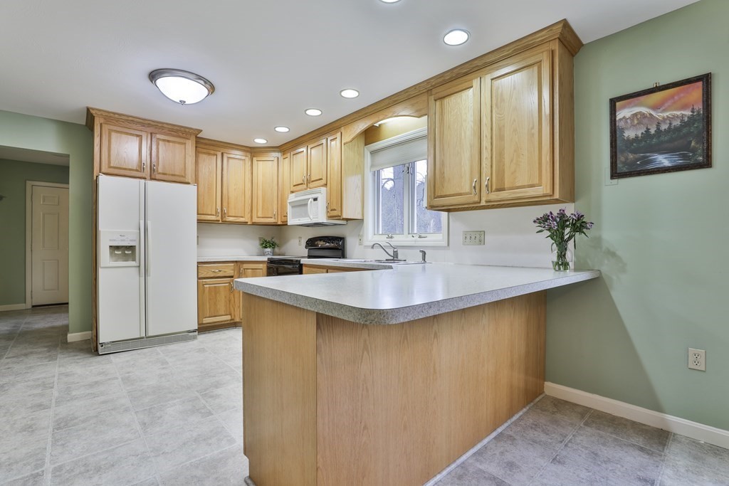 40 Mallard Point Road Merrimack, NH 03054 - Photo 6 of 40 a kitchen with stainless steel appliances granite countertop a sink stove and refrigerator
