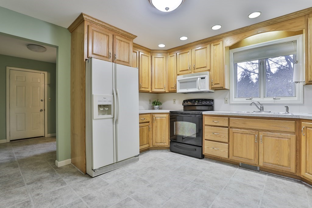 40 Mallard Point Road Merrimack, NH 03054 - Photo 7 of 40 a kitchen with granite countertop a refrigerator stove top oven and sink