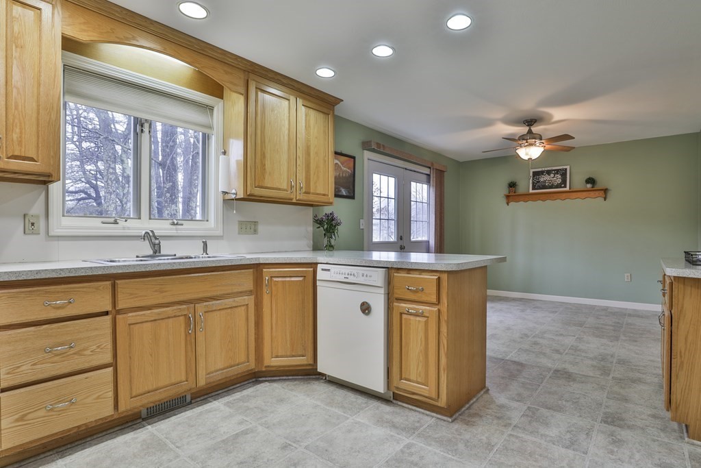 40 Mallard Point Road Merrimack, NH 03054 - Photo 8 of 40 a kitchen with granite countertop a sink cabinets stainless steel appliances and a granite counter tops