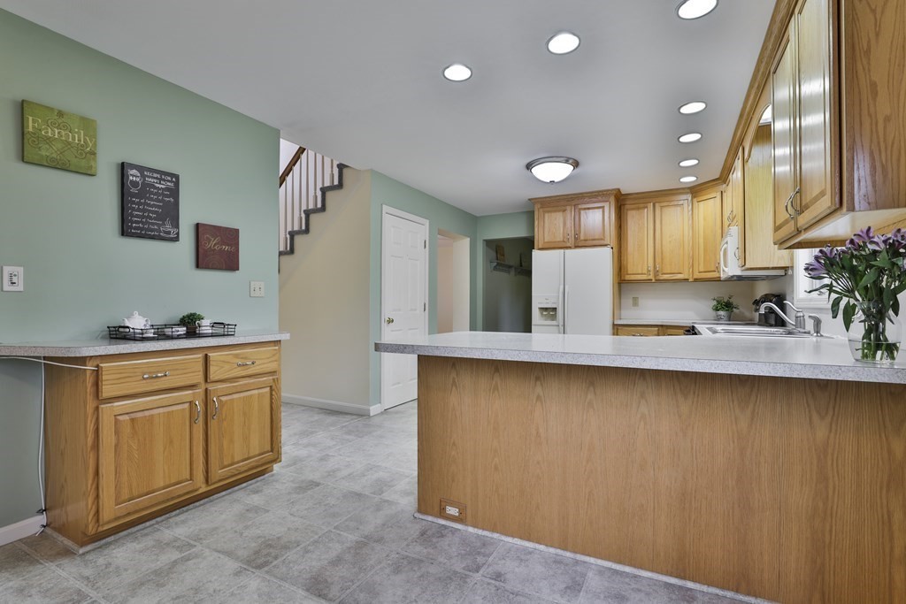 40 Mallard Point Road Merrimack, NH 03054 - Photo 10 of 40 a large kitchen with stainless steel appliances granite countertop a sink and cabinets