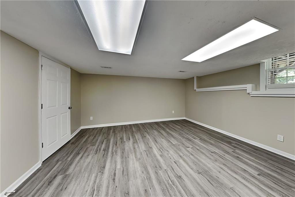 166 Kelly Court Dallas, GA 30157 - Photo 14 of 19 a view of an empty room with wooden floor and a window