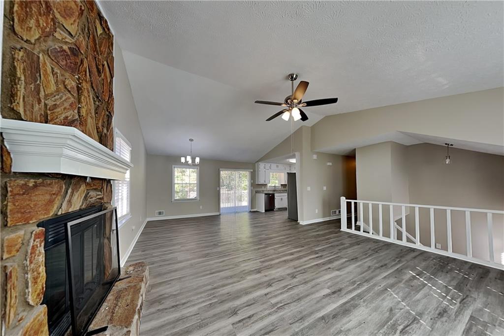 166 Kelly Court Dallas, GA 30157 - Photo 2 of 19 a view of a livingroom with wooden floor and staircase