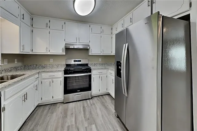a kitchen with cabinets and stainless steel appliances