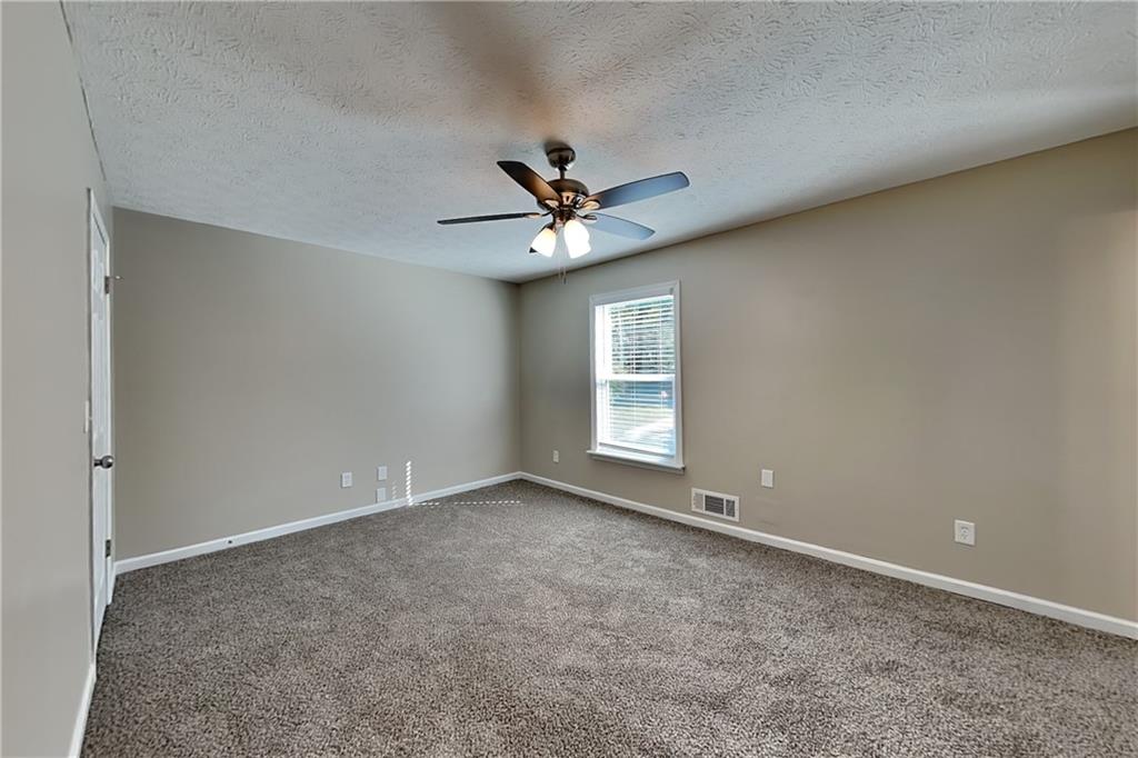 166 Kelly Court Dallas, GA 30157 - Photo 5 of 19 an empty room with windows and ceiling fan
