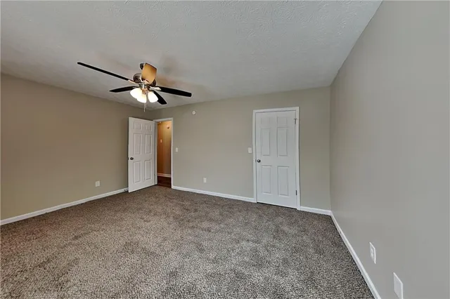 a view of a livingroom with a chandelier fan
