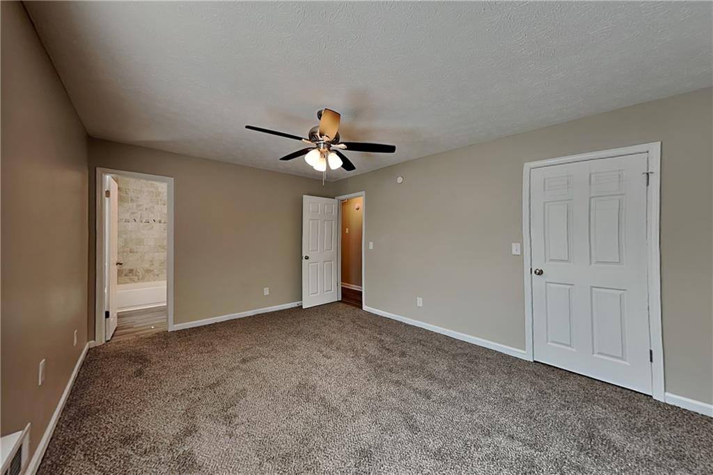 166 Kelly Court Dallas, GA 30157 - Photo 7 of 19 a view of an empty room with window and chandelier fan