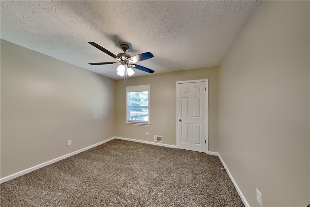 166 Kelly Court Dallas, GA 30157 - Photo 9 of 19 a view of an empty room with a window