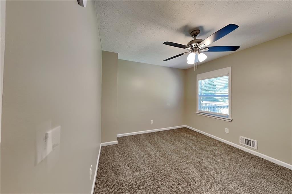 166 Kelly Court Dallas, GA 30157 - Photo 10 of 19 an empty room with windows and fan