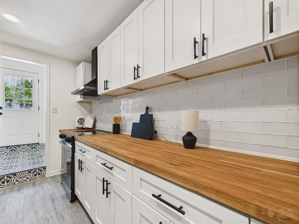 6108 Shadow Valley Drive, Unit A Austin, TX 78731 - Photo 19 of 31 a view of a kitchen with cabinets and wooden floor