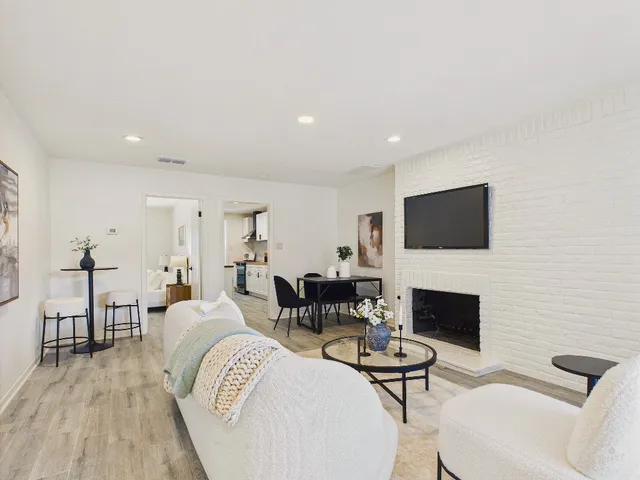 a living room with furniture wooden floor and a fireplace