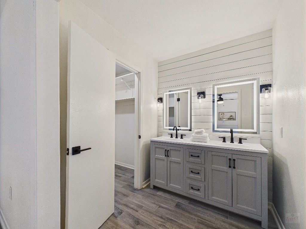 6108 Shadow Valley Drive, Unit A Austin, TX 78731 - Photo 27 of 31 a bathroom with a double vanity sink a mirror and a shower