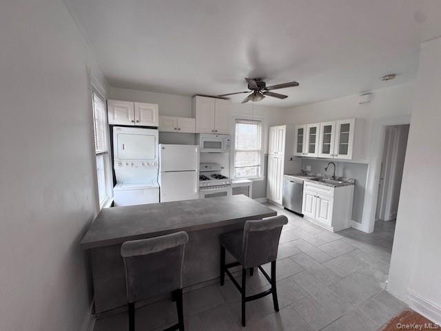 530 Fourth Avenue, Unit 2 Pelham, NY 10803 - Photo 3 of 8 a kitchen with granite countertop a table chairs refrigerator and cabinets